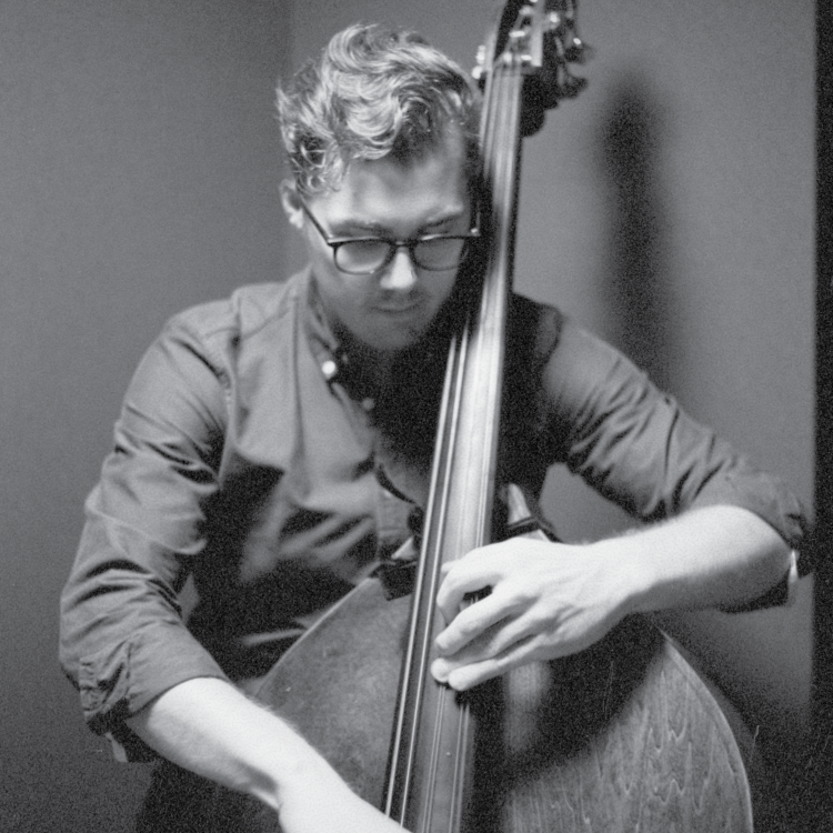 Black and white image of Alexander Svensen looking down as he plays the bass.